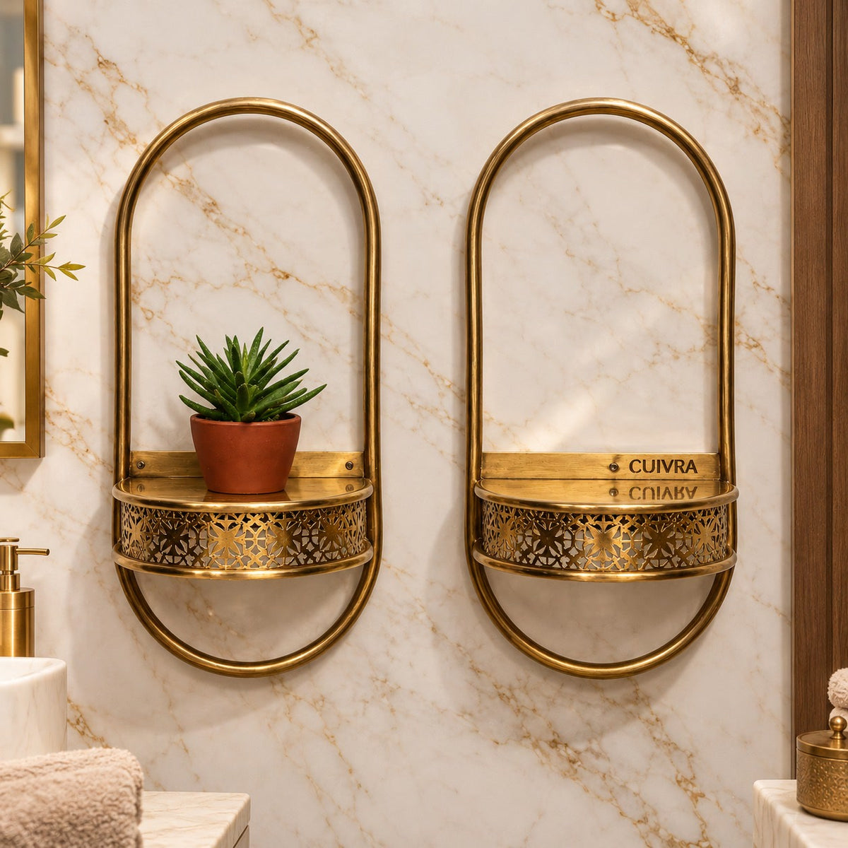 Close-up of two Aura brass shelves with CUIVRA engraving on marble