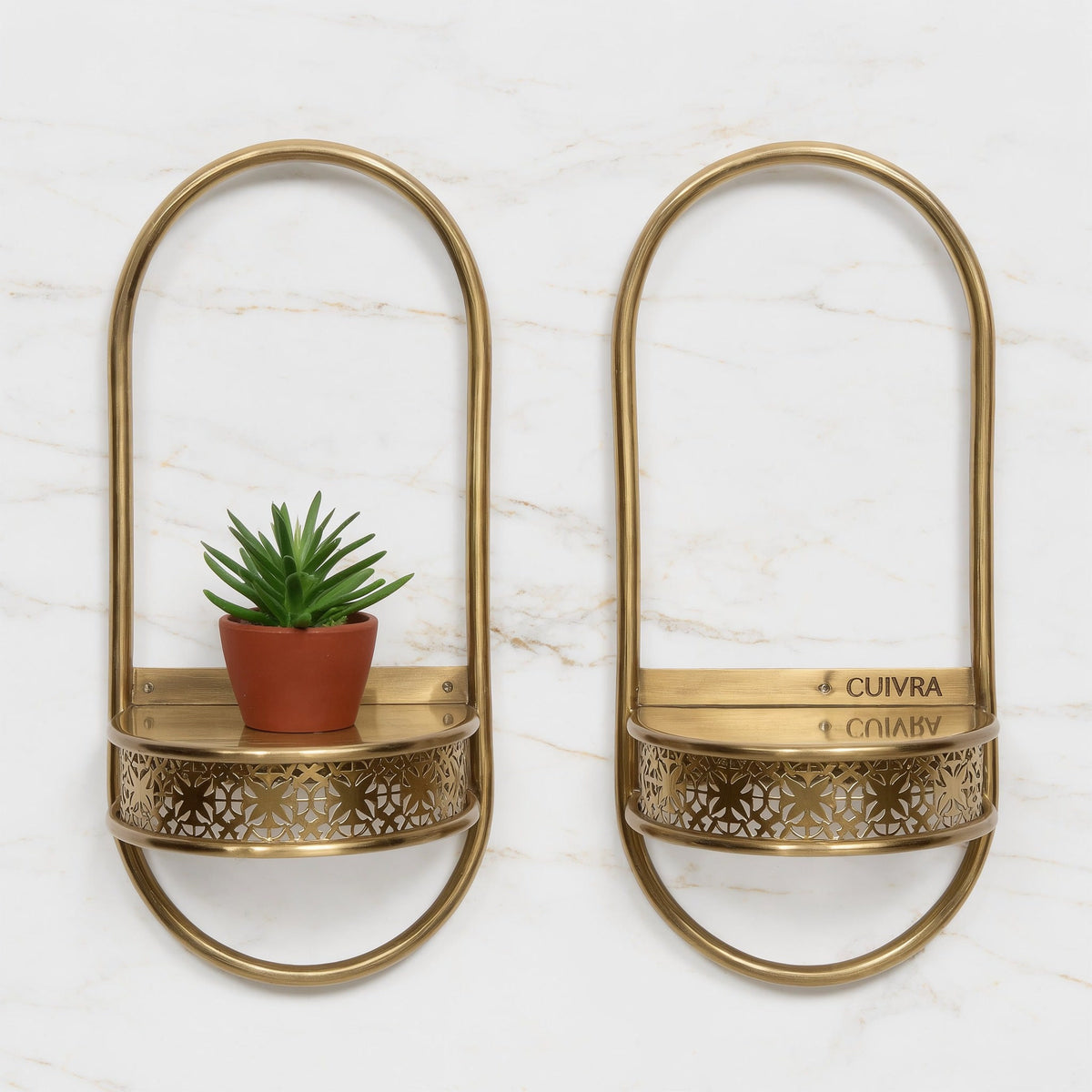 Pair of Aura brass wall shelves by Cuivra on white marble