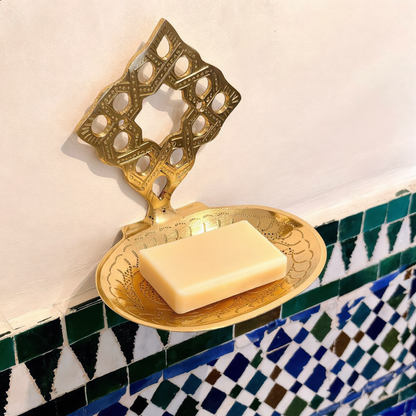 Hand-engraved brass wall soap dish with soap in a Moroccan bathroom, Cuivra