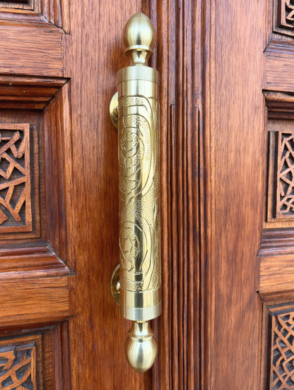 Brass door handle on a carved Moroccan cedar riad door