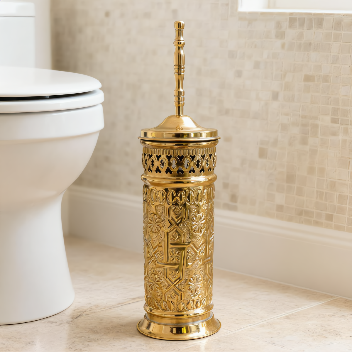 Engraved brass toilet brush holder beside a toilet in a travertine bathroom, Cuivra