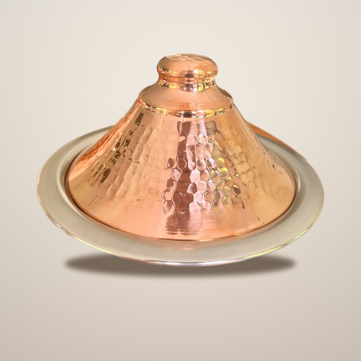 Dyafa hand-hammered red copper tajine on a clean studio background, Cuivra