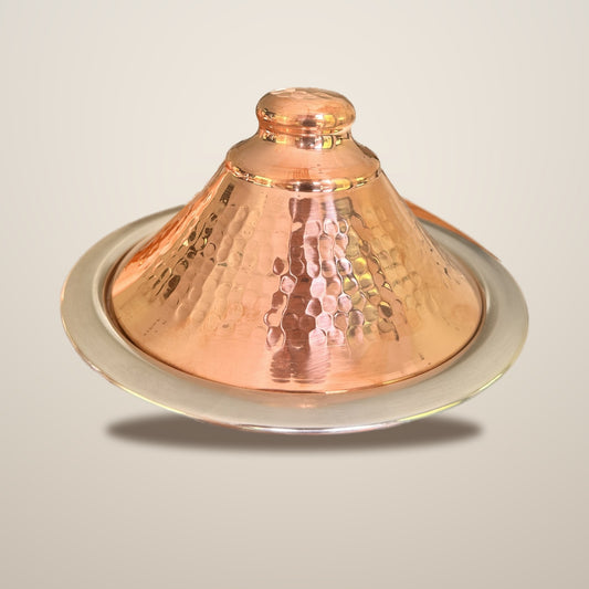 Dyafa hand-hammered red copper tajine on a clean studio background, Cuivra